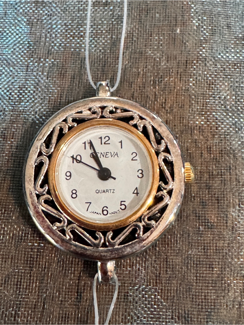 Geneva Silver and Gold Round Filigree Pendant Watch face